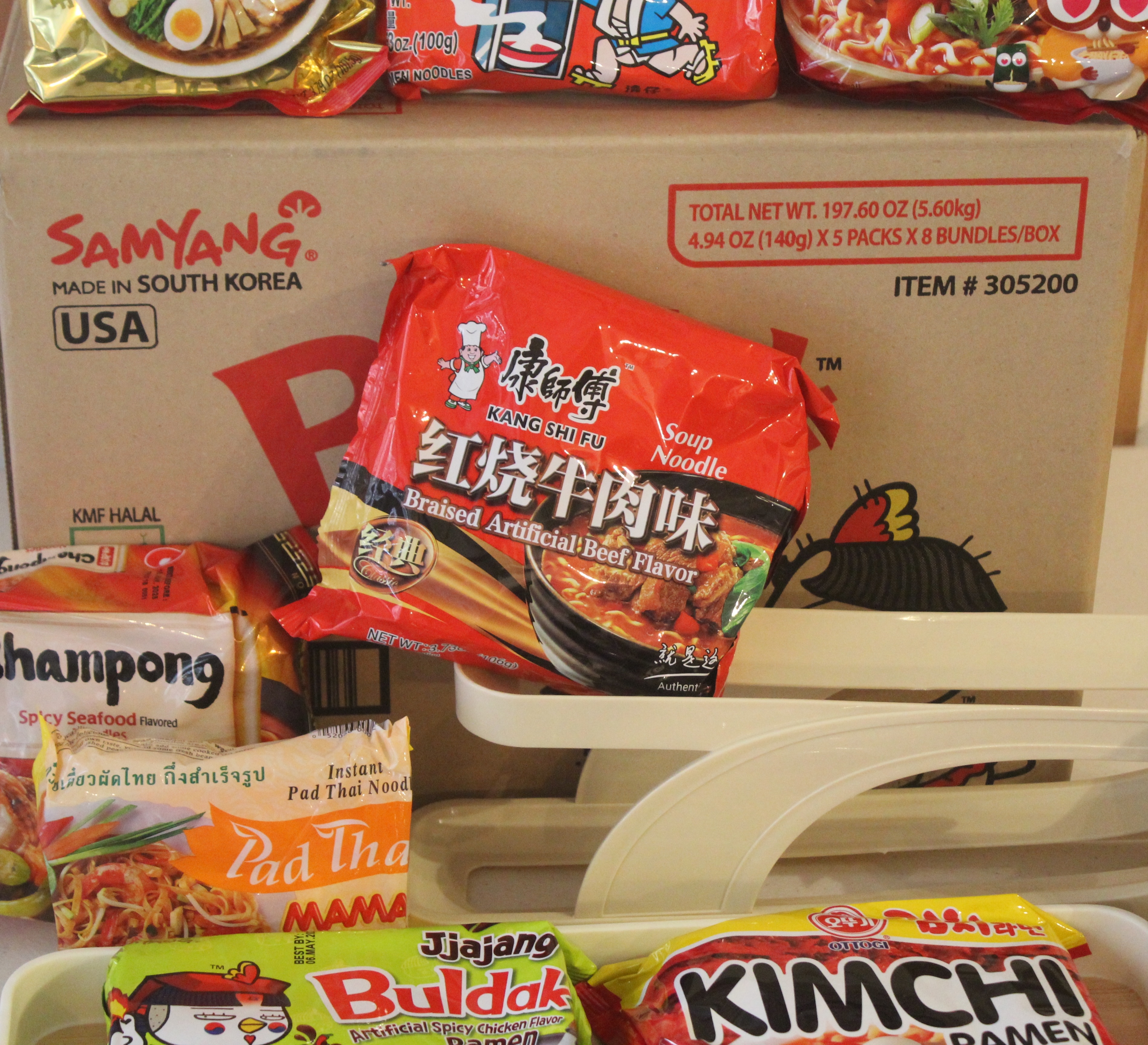 a white cardboard box with instant noodles floating out
